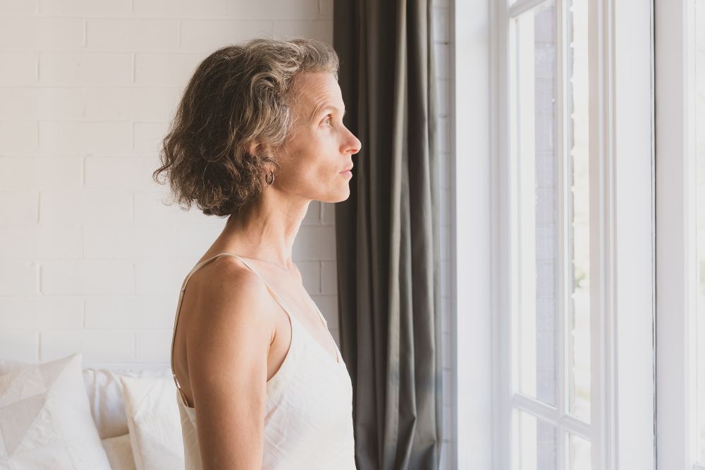 Mature woman looking out the window