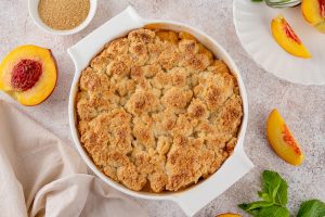 Pregnancy-friendly dessert cobbler for expecting moms laid out on a table with peaches